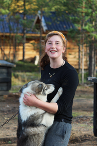 A Hetta Huskies guide with one of the dogs in day care